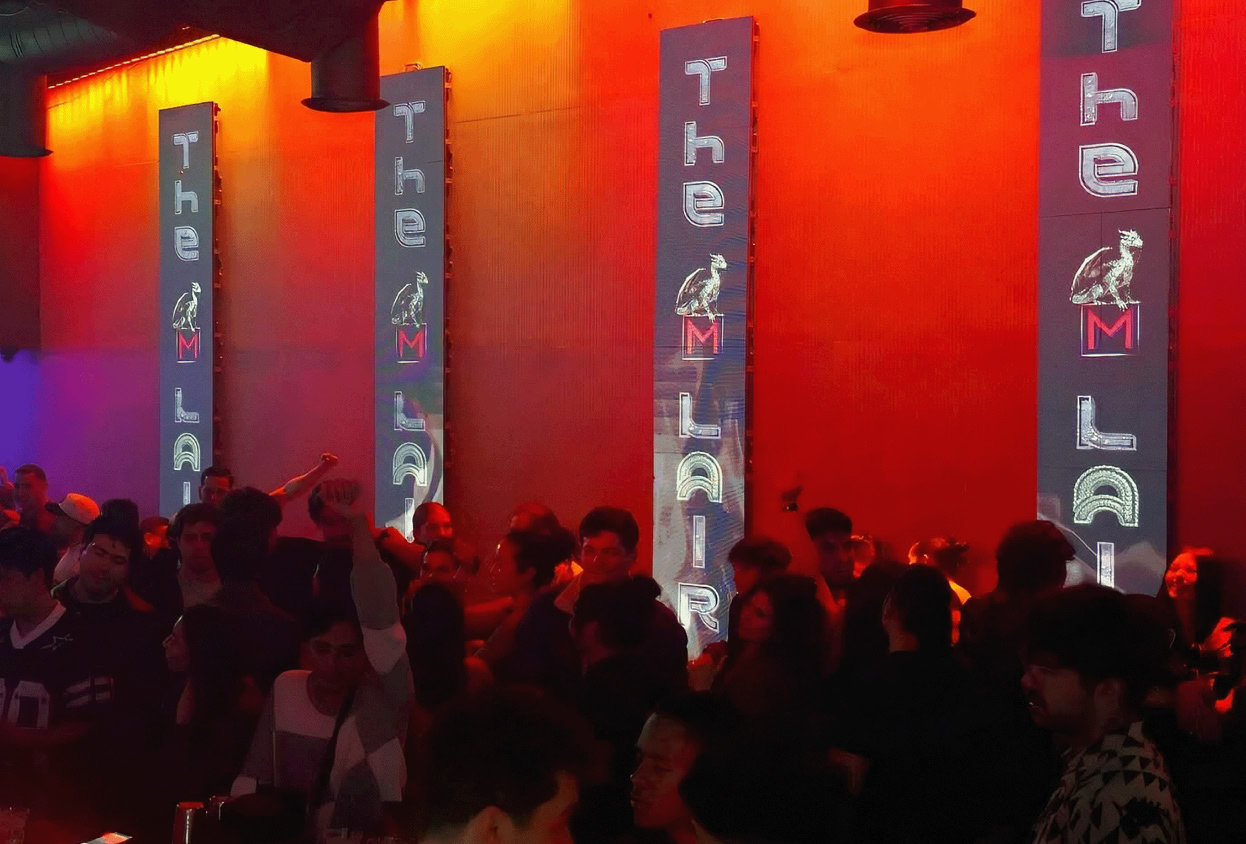 Blurred image capturing the dynamic motion of dancing in vibrant red lighting.