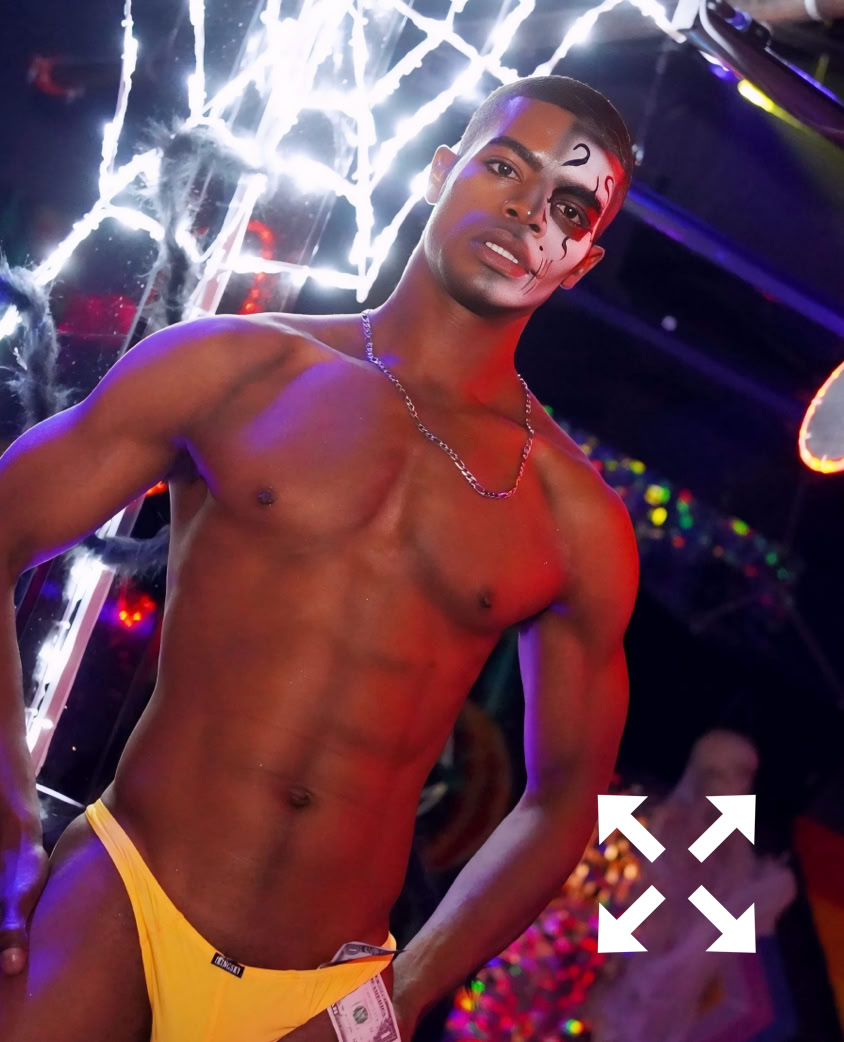 Subtle illumination emphasizes the car's tail light in a dim parking lot at night.