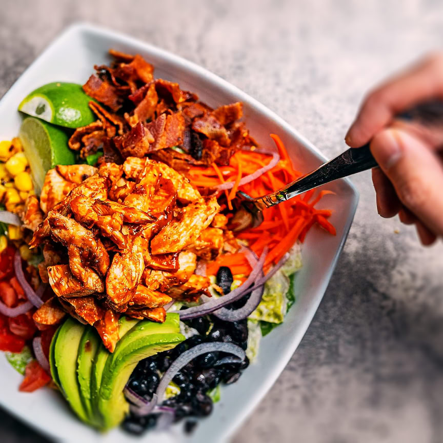 A delightful meal featuring cheese, wine, fries, and salad in a cozy French setting.